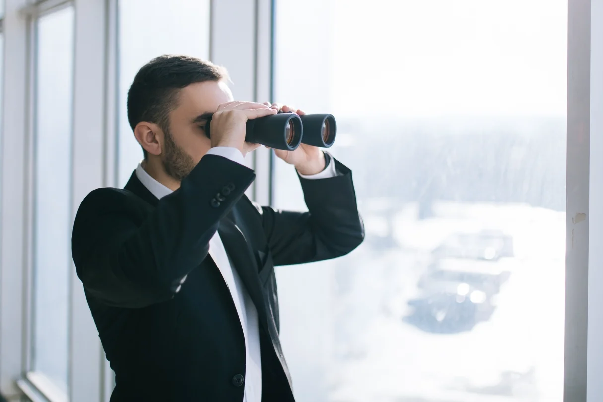 a man eyeing something using telescope